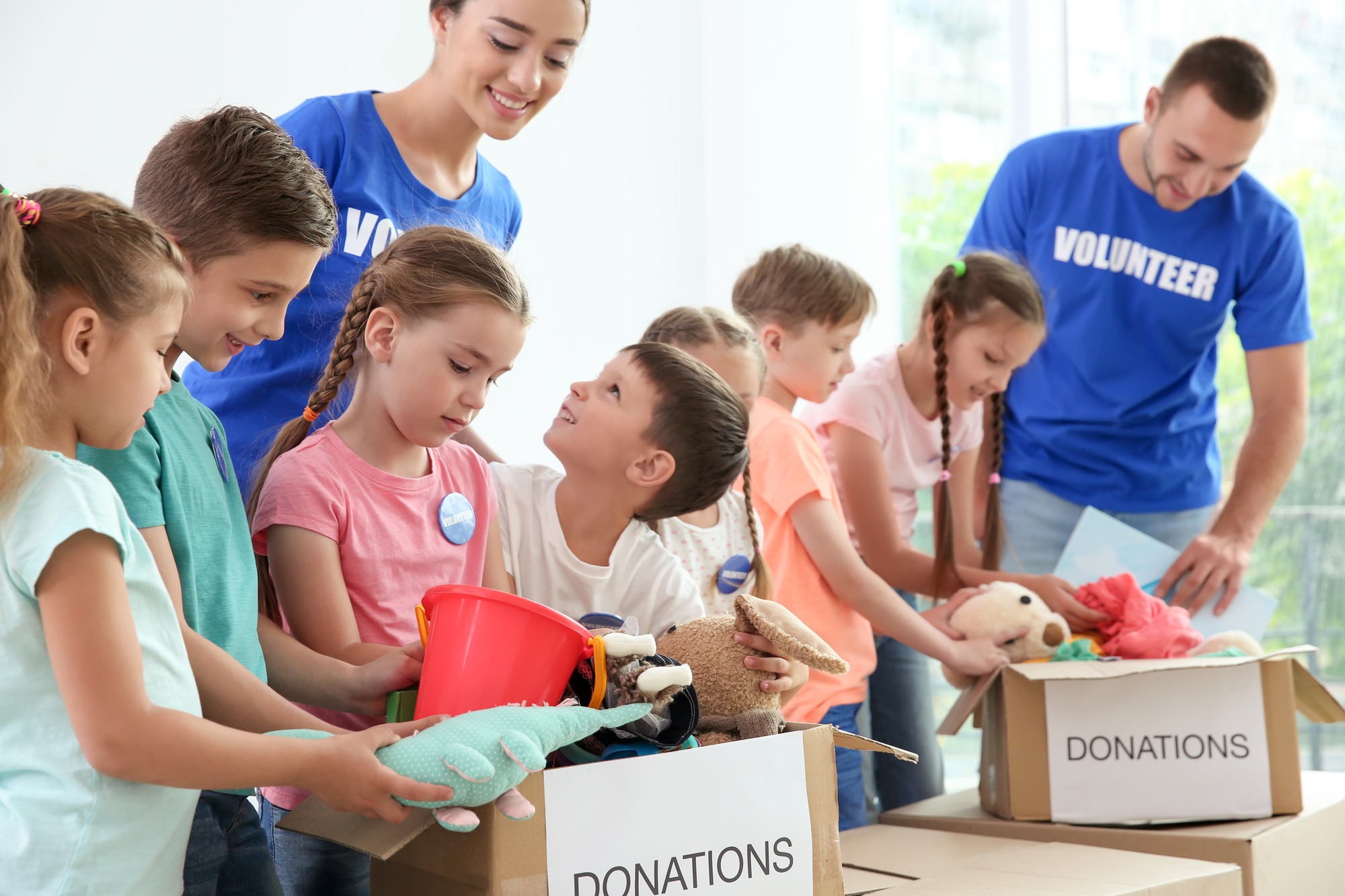 Volunteers with children sorting donation goods
